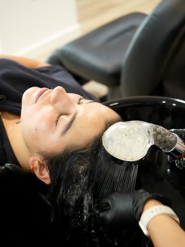 Lavagem no salão, com o cabelo a ser molhado no lavatório